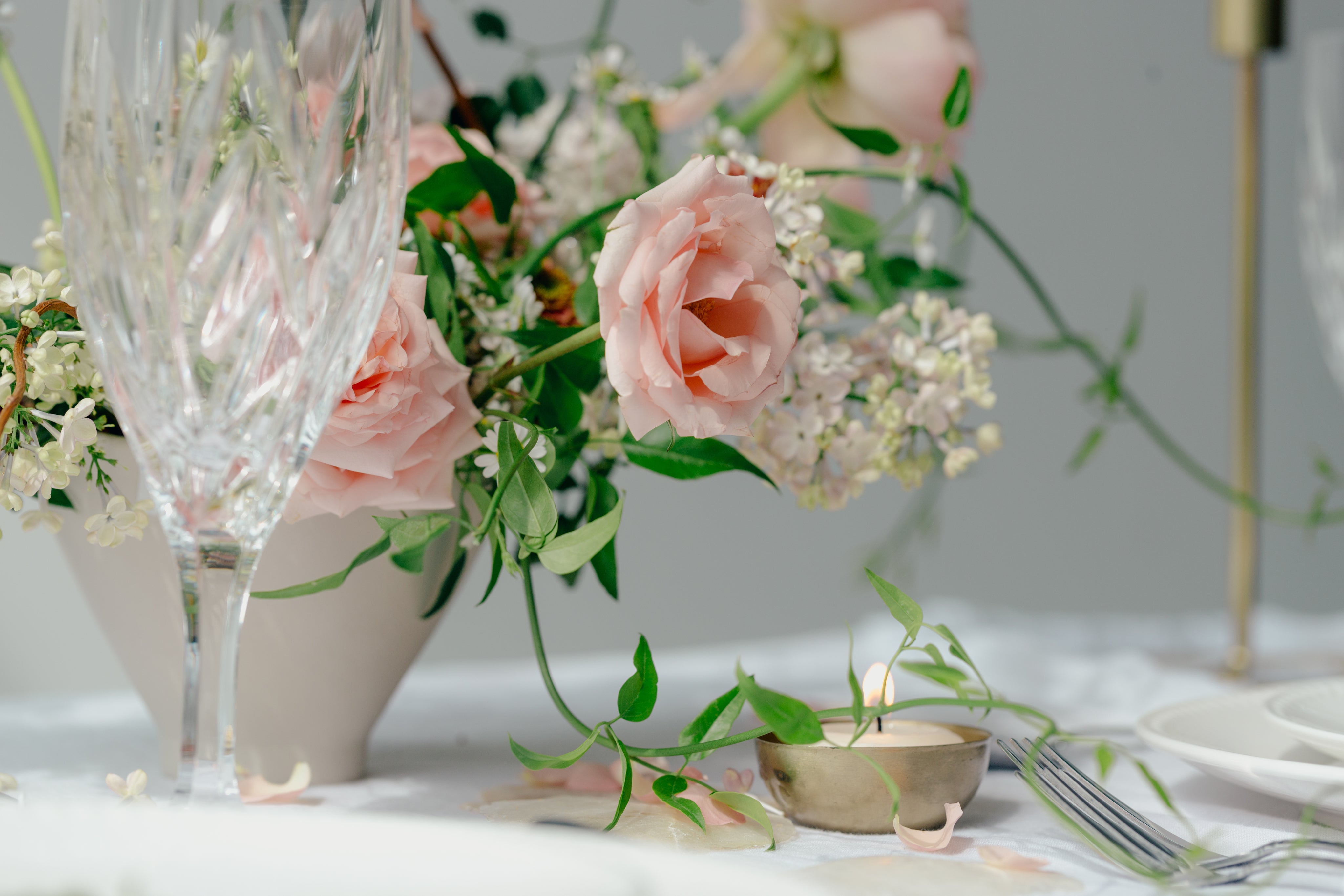 files/peach-roses-on-table-with-glass.jpg